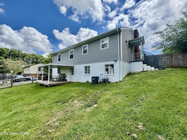 back of property featuring cooling unit, a wooden deck, and a chimney