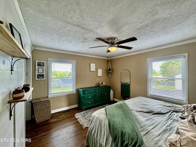 bedroom with dark wood finished floors, ornamental molding, baseboards, a textured ceiling, and ceiling fan