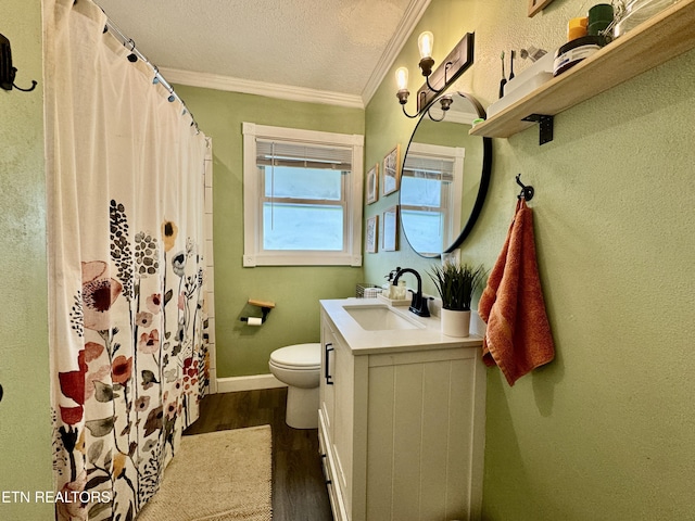 bathroom featuring wood finished floors, toilet, ornamental molding, vanity, and a textured ceiling