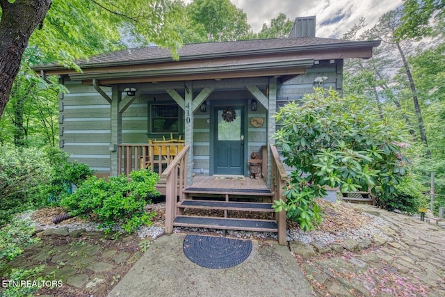 410 Sassafras Trl, Sevierville, TN 37876 - view of exterior entry with a chimney and a shingled roof