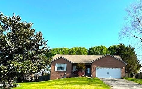 ranch-style home with a garage, a front lawn, and driveway