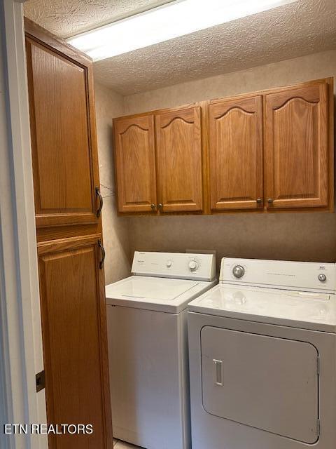 laundry area with cabinet space and washing machine and clothes dryer