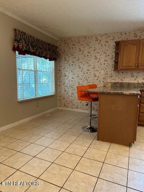 1745 Meadow Ridge Cir, Sevierville, TN 37862 - unfurnished dining area with light tile patterned flooring and crown molding