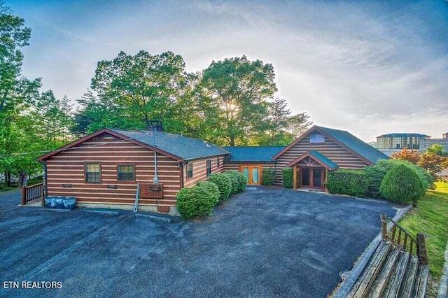 view of front of home featuring asphalt driveway and french doors