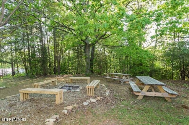 view of yard featuring an outdoor fire pit
