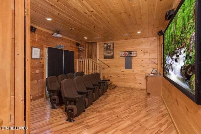 cinema with wooden ceiling, wooden walls, recessed lighting, light wood finished floors, and electric panel