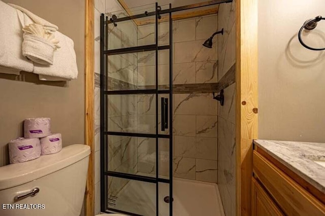 full bath with a shower stall, toilet, and vanity