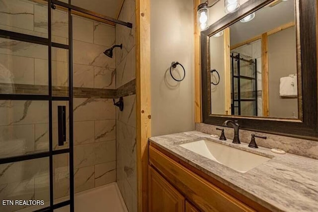 bathroom featuring a shower stall and vanity