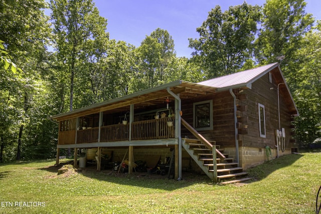 back of property with a lawn and metal roof
