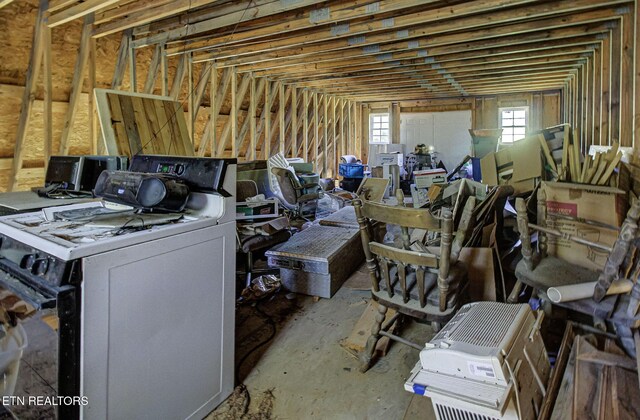 miscellaneous room featuring washer / clothes dryer and vaulted ceiling