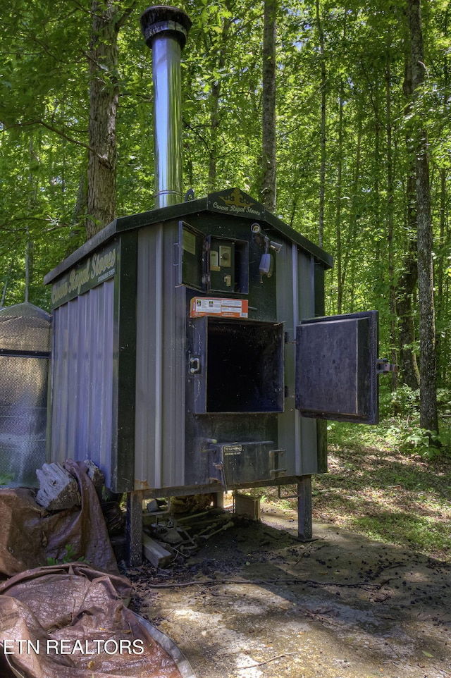 view of outbuilding featuring a forest view