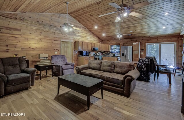 living room with ceiling fan, wooden ceiling, light wood-style floors, wood walls, and high vaulted ceiling