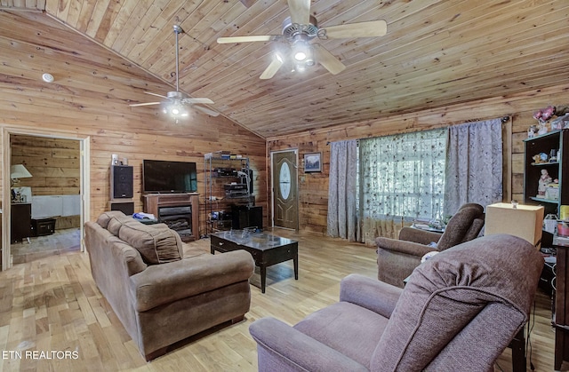 living room featuring wood walls, a ceiling fan, high vaulted ceiling, wood finished floors, and wooden ceiling