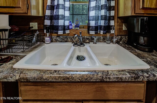 kitchen view of dark countertops and brown cabinets