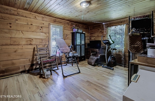 workout room featuring wooden walls, wood finished floors, and wooden ceiling