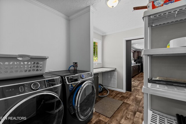 1452 Lower English Creek Rd, Newport, TN 37821 - clothes washing area featuring washing machine and clothes dryer, ornamental molding, wood finished floors, and a textured ceiling