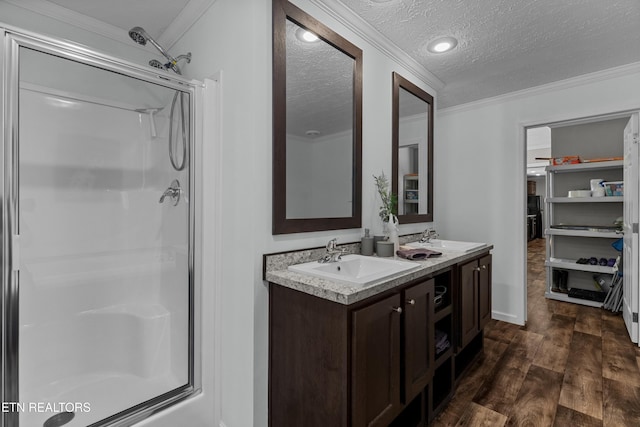 1452 Lower English Creek Rd, Newport, TN 37821 - bathroom featuring a stall shower, a textured ceiling, wood finished floors, crown molding, and double vanity