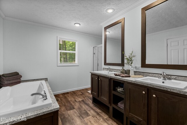 1452 Lower English Creek Rd, Newport, TN 37821 - full bath with crown molding, wood finished floors, a textured ceiling, double vanity, and a garden tub