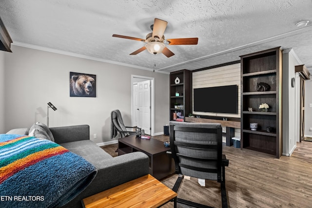 1452 Lower English Creek Rd, Newport, TN 37821 - living area featuring a ceiling fan, wood finished floors, baseboards, a textured ceiling, and crown molding