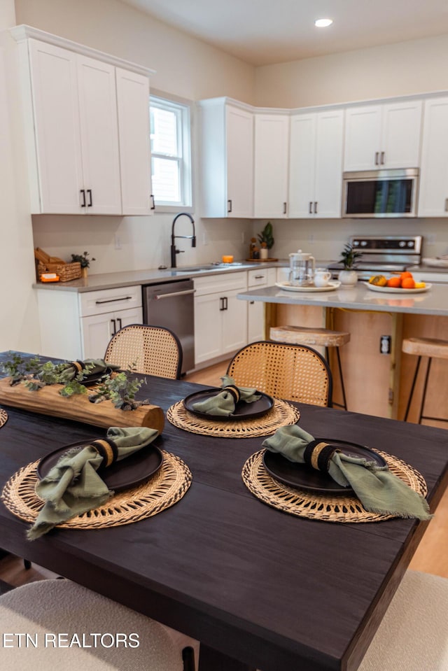 12516 Dalton View Ln, Knoxville, TN 37932 - kitchen with stove, dishwasher, white cabinetry, and recessed lighting