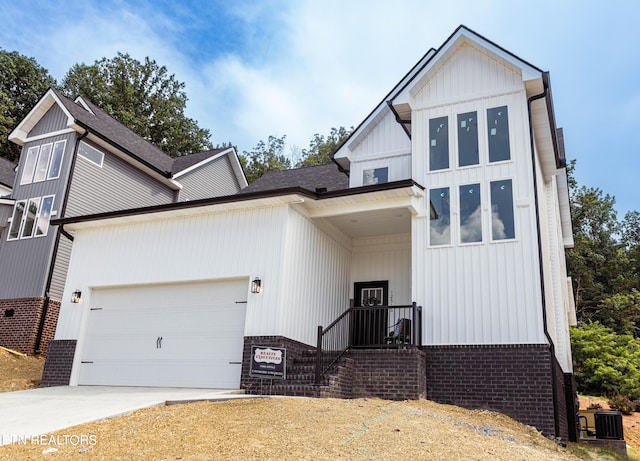12516 Dalton View Ln, Knoxville, TN 37932 - modern farmhouse featuring brick siding, a garage, driveway, board and batten siding, and roof with shingles