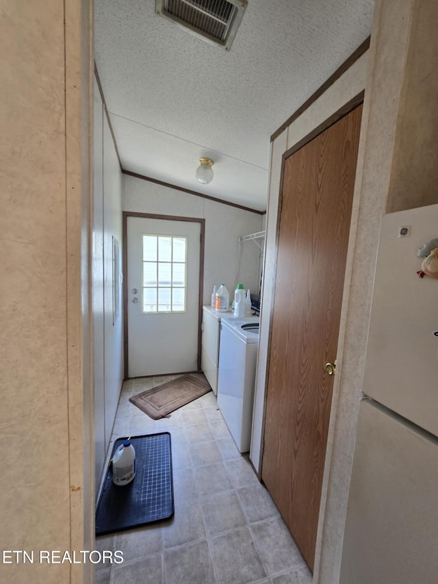 3023 Cave Springs Rd, Tazewell, TN 37879 - clothes washing area featuring washer and dryer, a textured ceiling, and ornamental molding