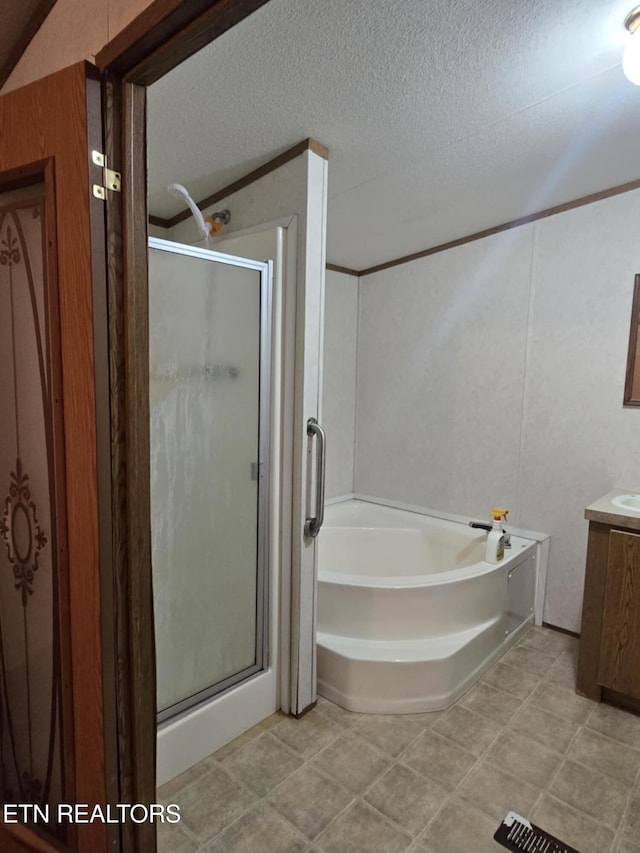 3023 Cave Springs Rd, Tazewell, TN 37879 - bathroom with vanity, a stall shower, a garden tub, and a textured ceiling