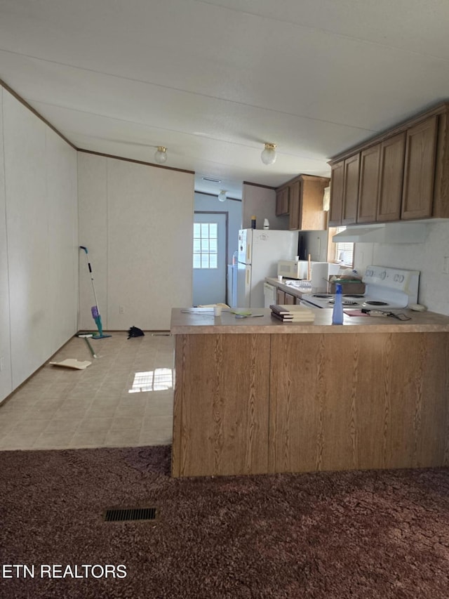 3023 Cave Springs Rd, Tazewell, TN 37879 - kitchen featuring white appliances, a peninsula, brown cabinets, and light flooring