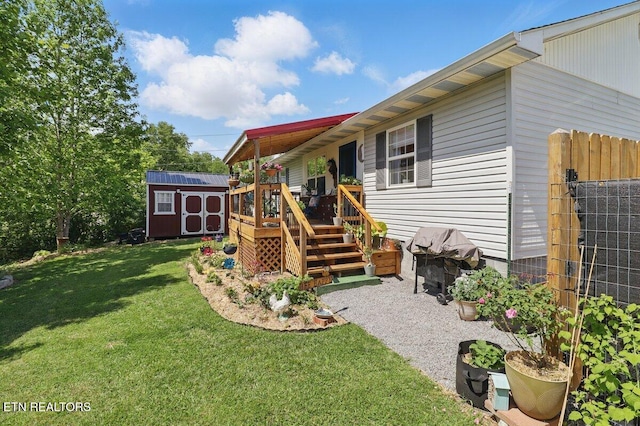 164 Walker Ln, Middlesboro, KY 40965 - rear view of house featuring a storage unit, an outdoor structure, a yard, and a deck