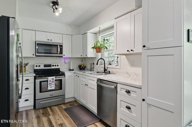 164 Walker Ln, Middlesboro, KY 40965 - kitchen with appliances with stainless steel finishes, a sink, and white cabinetry