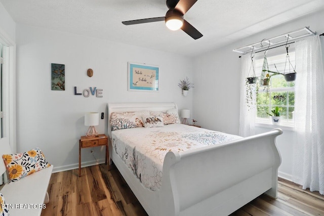 164 Walker Ln, Middlesboro, KY 40965 - bedroom featuring wood finished floors, a ceiling fan, and baseboards