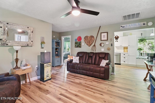 164 Walker Ln, Middlesboro, KY 40965 - living room with a ceiling fan, light wood-style floors, a textured ceiling, and baseboards
