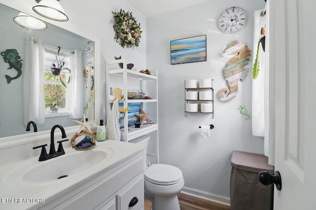 164 Walker Ln, Middlesboro, KY 40965 - half bathroom with toilet, vanity, wood finished floors, and baseboards