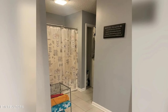 10008 Greylock Way, Knoxville, TN 37931 - full bath featuring a textured ceiling, tile patterned flooring, baseboards, and a shower with curtain