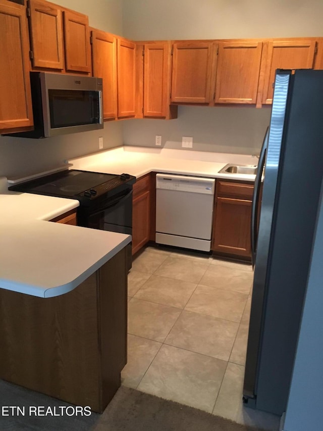 10008 Greylock Way, Knoxville, TN 37931 - kitchen with stainless steel appliances, a peninsula, light countertops, a sink, and light tile patterned floors