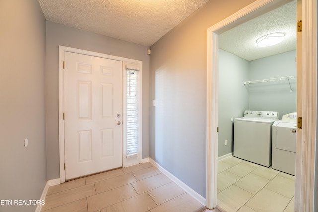 10008 Greylock Way, Knoxville, TN 37931 - entrance foyer with washing machine and dryer, a textured ceiling, light tile patterned floors, and baseboards