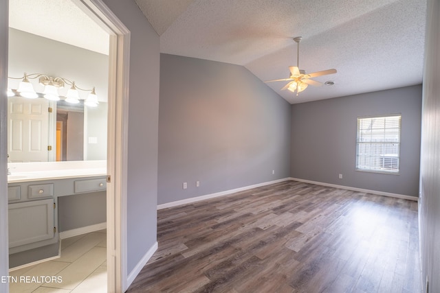 10008 Greylock Way, Knoxville, TN 37931 - unfurnished room featuring ceiling fan, light wood finished floors, vaulted ceiling, a textured ceiling, and a sink