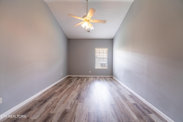 10008 Greylock Way, Knoxville, TN 37931 - unfurnished room with wood finished floors, a textured ceiling, a ceiling fan, vaulted ceiling, and baseboards