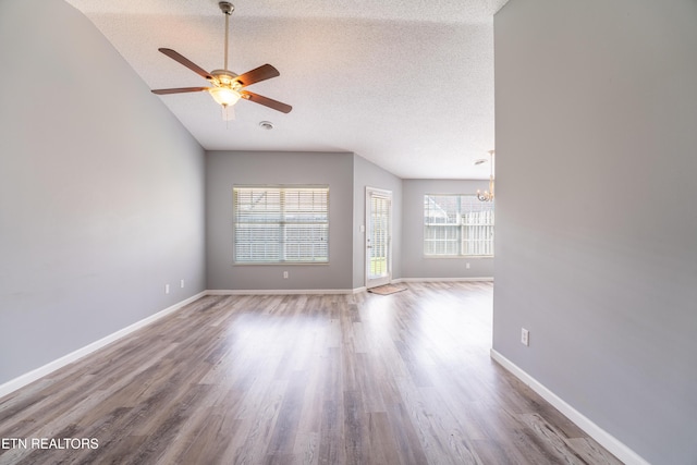 10008 Greylock Way, Knoxville, TN 37931 - empty room with ceiling fan, a textured ceiling, a chandelier, wood finished floors, and baseboards