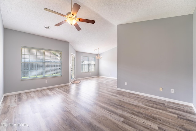 10008 Greylock Way, Knoxville, TN 37931 - unfurnished room featuring a textured ceiling, wood finished floors, a chandelier, a ceiling fan, and baseboards