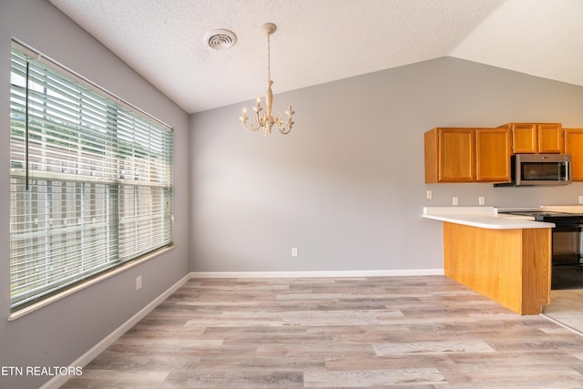 10008 Greylock Way, Knoxville, TN 37931 - kitchen featuring stainless steel microwave, vaulted ceiling, a chandelier, a peninsula, and black range oven