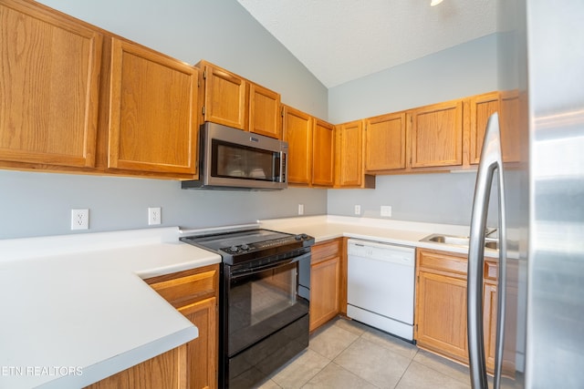 10008 Greylock Way, Knoxville, TN 37931 - kitchen featuring stainless steel appliances, vaulted ceiling, light tile patterned flooring, light countertops, and a textured ceiling