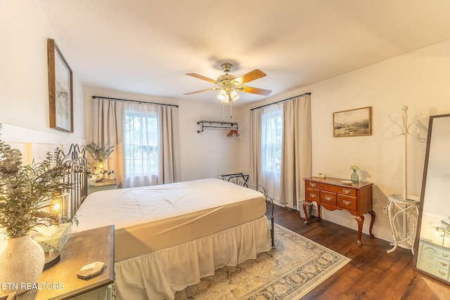 bedroom featuring dark wood-type flooring and a ceiling fan