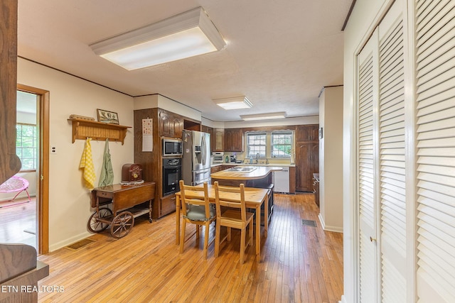 dining room with light wood-style floors and baseboards