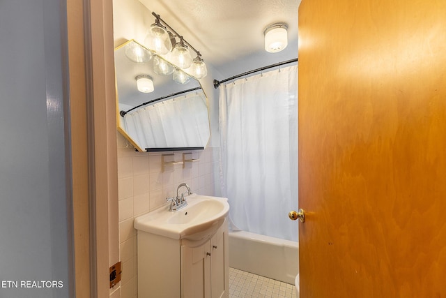 full bathroom featuring vanity, tile patterned floors, and shower / bathtub combination with curtain