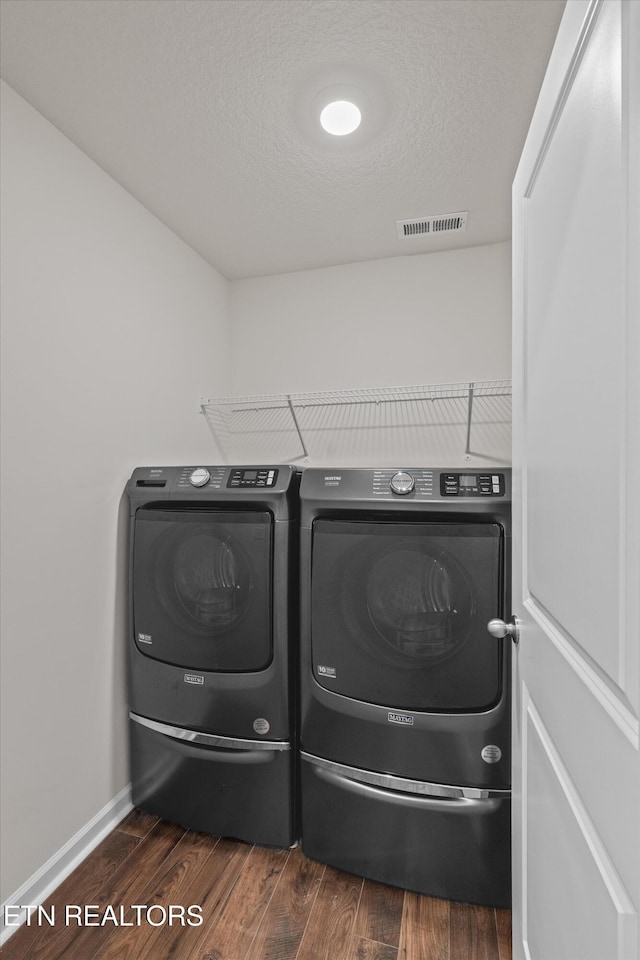 7813 Night Shade Ln, Knoxville, TN 37938 - laundry room featuring washer and clothes dryer, dark wood-style flooring, baseboards, and a textured ceiling