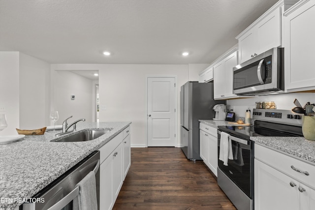7813 Night Shade Ln, Knoxville, TN 37938 - kitchen featuring appliances with stainless steel finishes, a sink, dark wood-style flooring, white cabinets, and recessed lighting