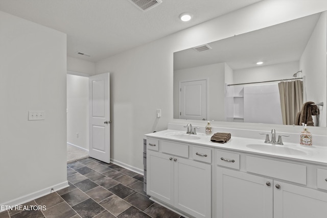 7813 Night Shade Ln, Knoxville, TN 37938 - full bathroom with baseboards, double vanity, a shower with curtain, recessed lighting, and stone finish flooring