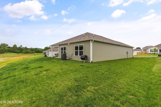 7813 Night Shade Ln, Knoxville, TN 37938 - rear view of house with a lawn and central AC unit