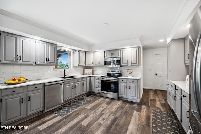 8307 Stoney View Ln, Corryton, TN 37721 - kitchen featuring gray cabinetry, appliances with stainless steel finishes, a sink, dark wood-style flooring, and tasteful backsplash